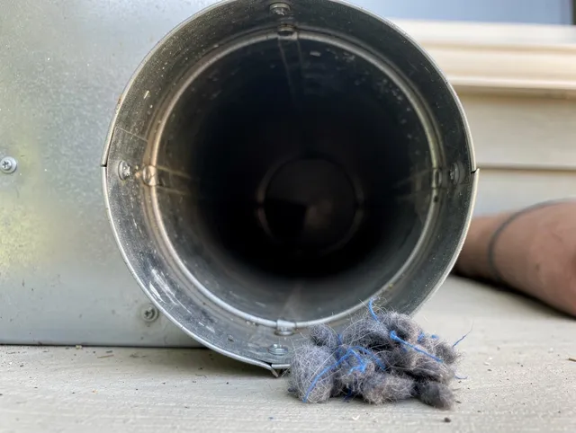 Garden City Dryer Vent Cleaning technician using specialized equipment to clear severe dryer vent blockage in Garden City